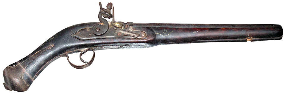 Detailed view of an antique flintlock pistol on display at the Palace Armoury in Valletta, Malta