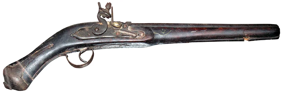 Detailed view of an antique flintlock pistol on display at the Palace Armoury in Valletta, Malta