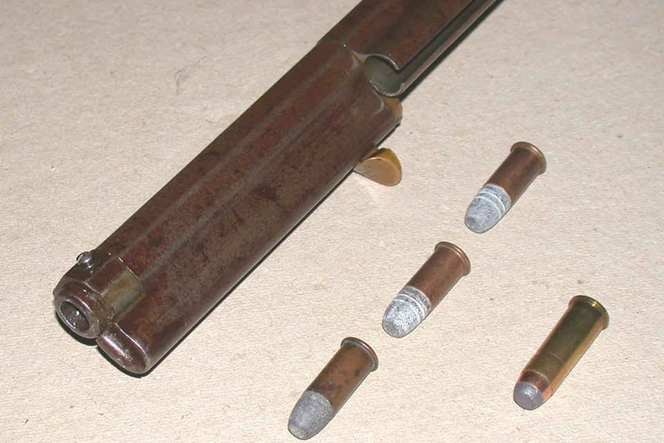 Henry lever-action rifle with various ammunition cartridges