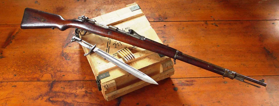 Iconic lever-action rifle - Mauser M98 rifle on a wooden surface with ammunition