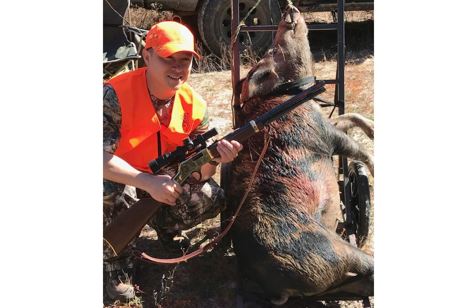 Feral hog being hunted with rifle to control property damage, an invasive species available year-round