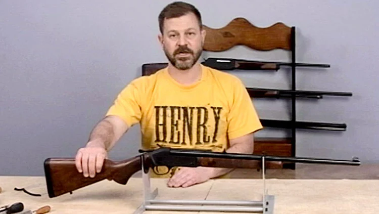 Man demonstrating proper firearm maintenance techniques for Henry rifles and shotguns