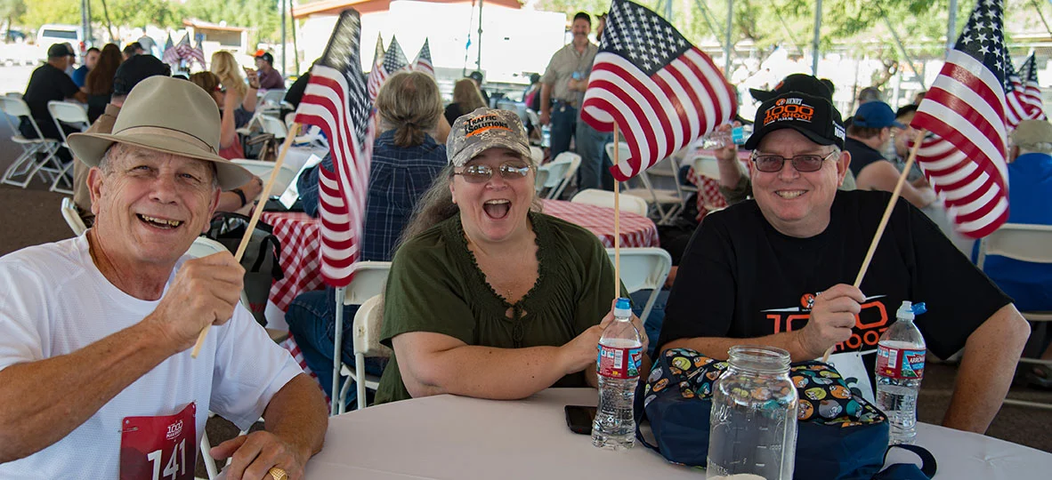 Enthusiastic group celebrating 1000 Man Shoot anniversary at Henry Repeating Arms event