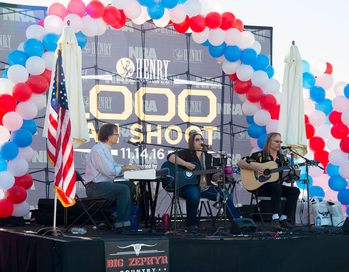 Henry Repeating Arms celebrates 1,000 Man Shoot anniversary with patriotic-themed stage, live music performance, and crowd of attendees