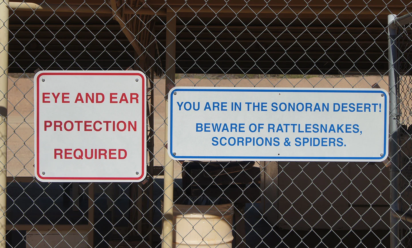 Warning signs in the Sonoran Desert about rattlesnakes, scorpions, and spiders
