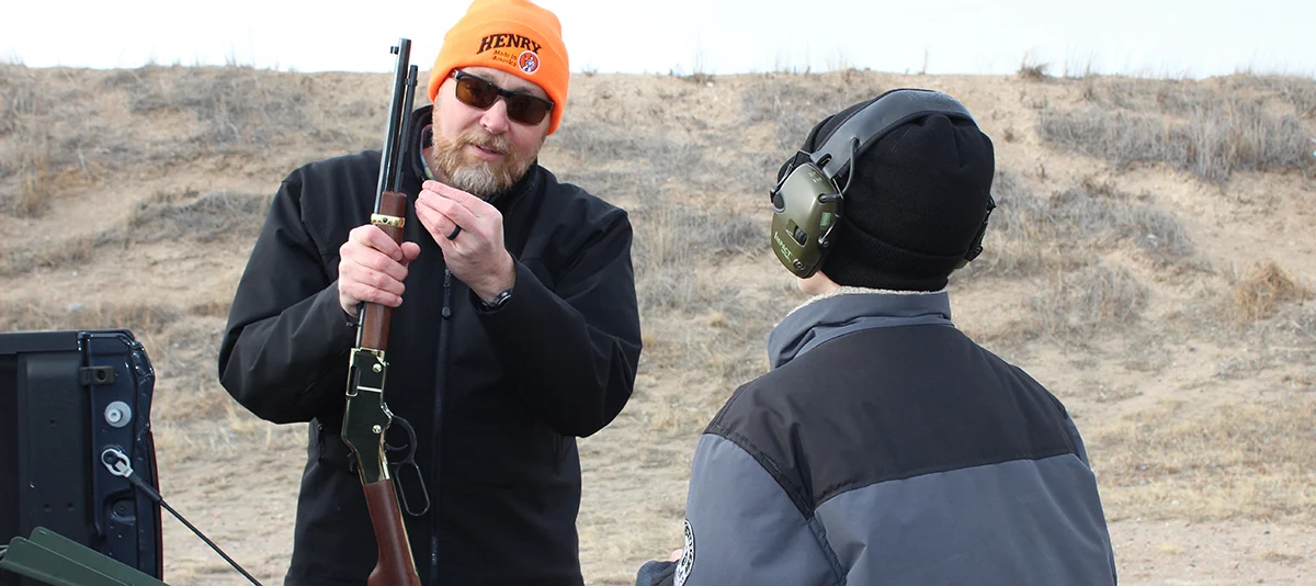 Father and son shooting rifles, passing down the legacy of firearms