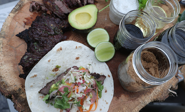 Grilled steak, avocado, and vegetables on soft taco shells