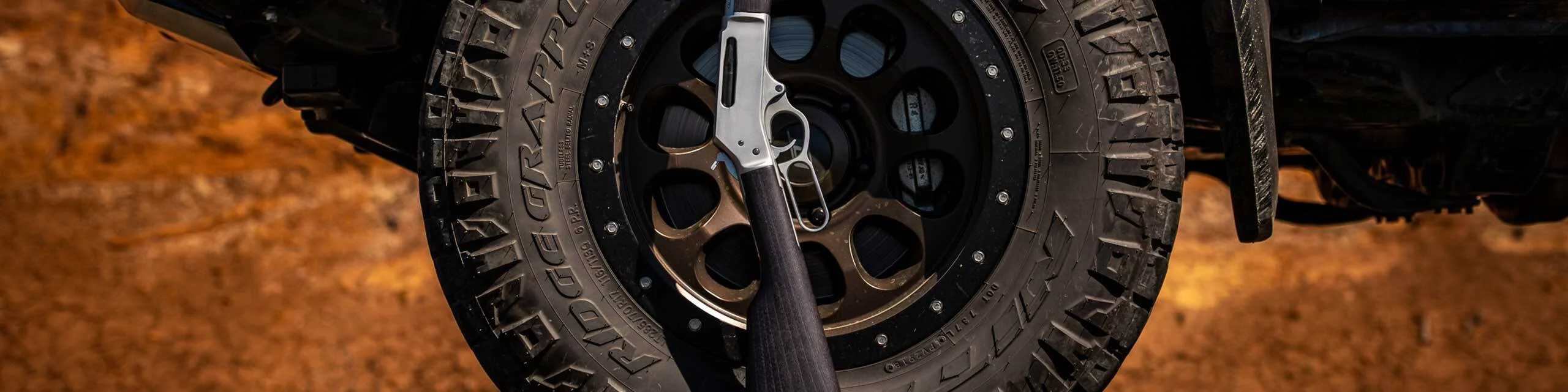Henry lever-action rifle with rugged all-terrain tires for versatile performance in outdoor and hunting settings