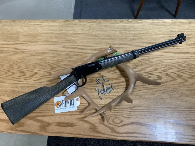 Henry Repeating Arms custom lever-action rifle with wood stock and silver-colored metal parts