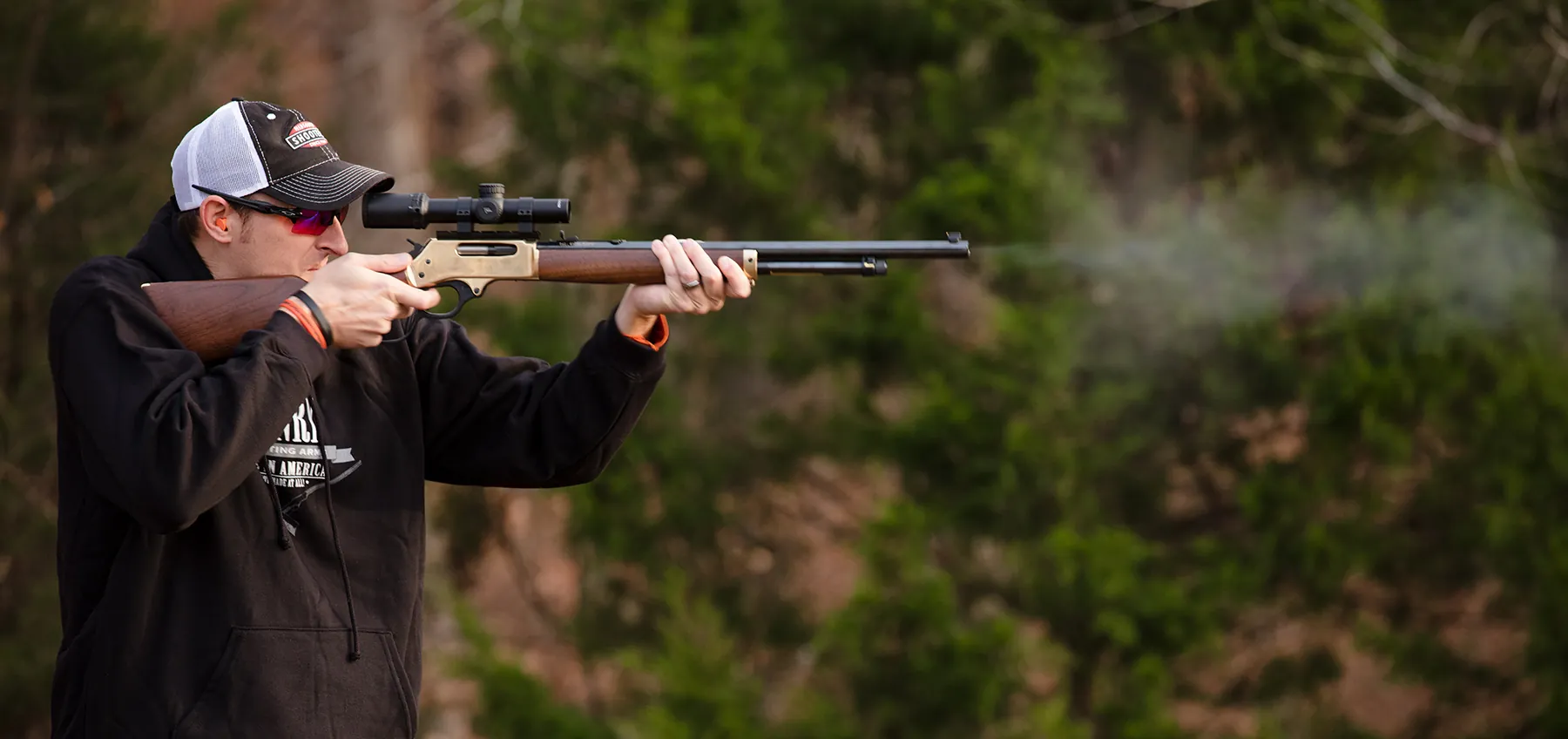 22Plinkster shooting a brass Henry rifle with a scope