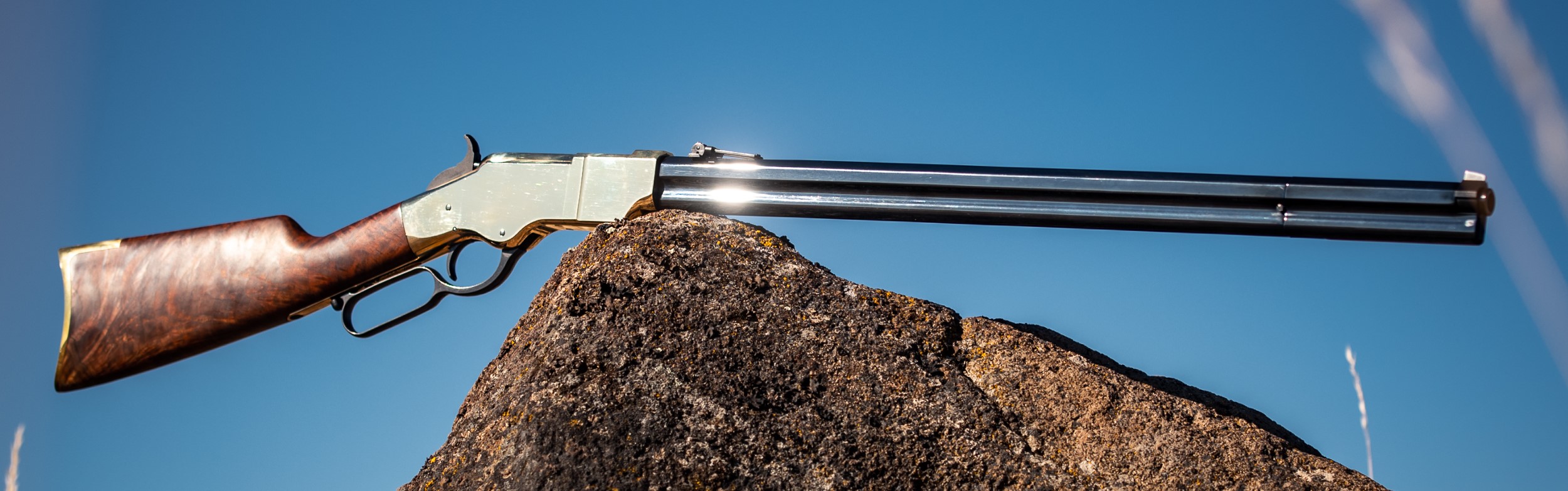 Photograph of New Original Henry Rifle balancing on a rock