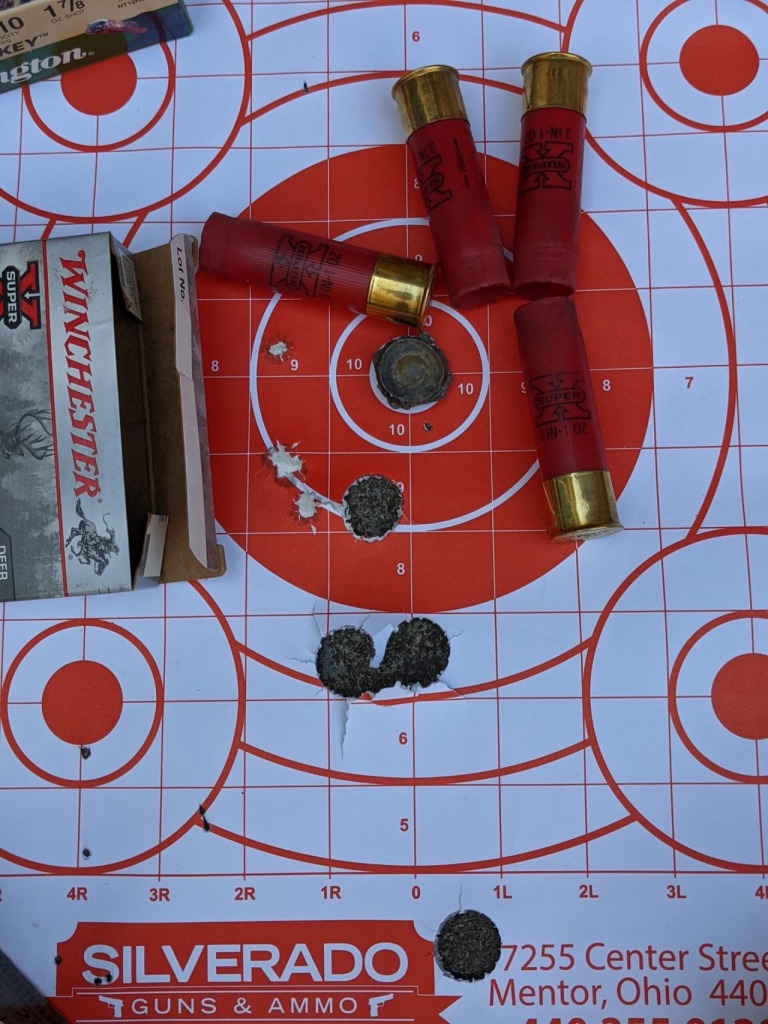 Paper target showing holes from 12 gauge shotgun slugs