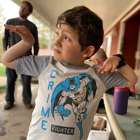 Young boy wearing a t-shirt with a crime fighter graphic