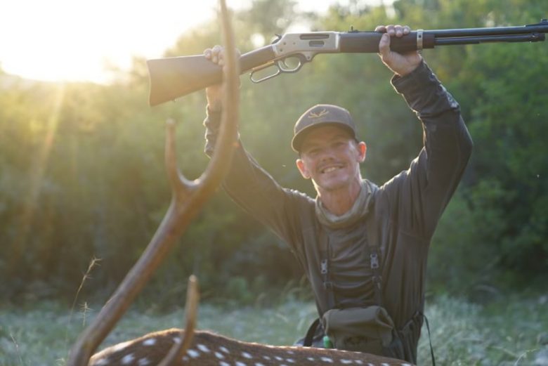 Geoff Rowley holding up a Henry rifle