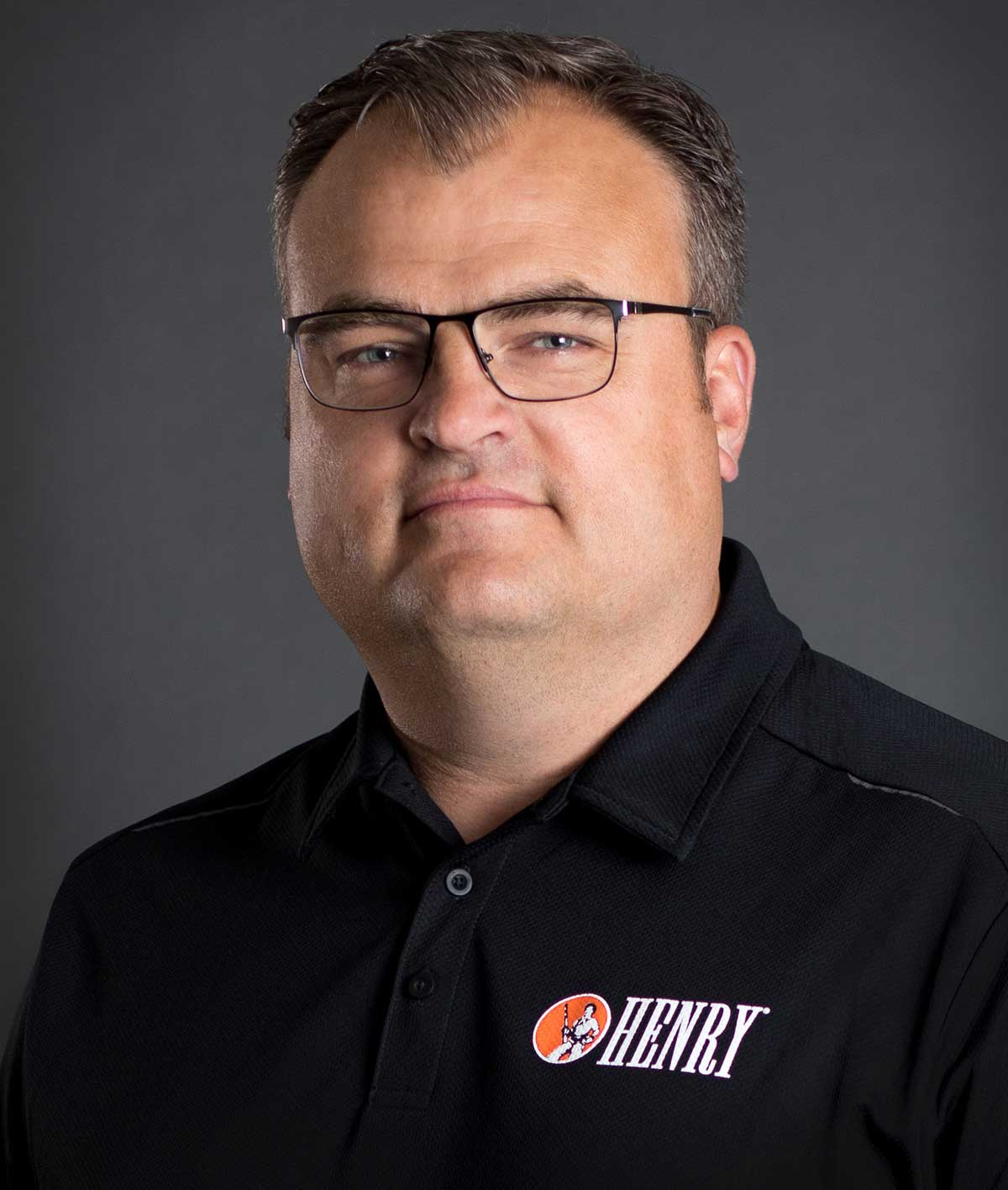 Portrait of Henry Repeating Arms President Andy Wickstrom wearing a black company shirt