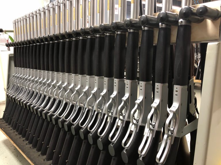 A rack of completed All-Weather .45-70 rifles awaiting final inspection and packaging.