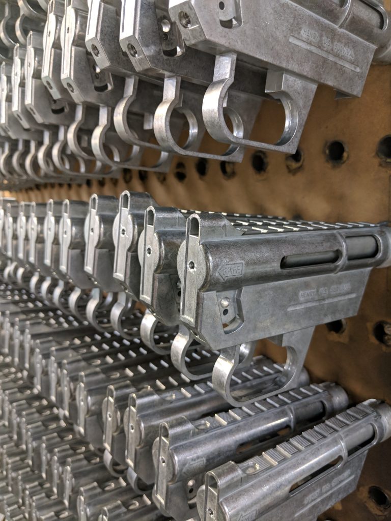A rack of unfinished U.S. Survival AR-7 receivers produced in Henry’s Rice Lake, Wisconsin facility.