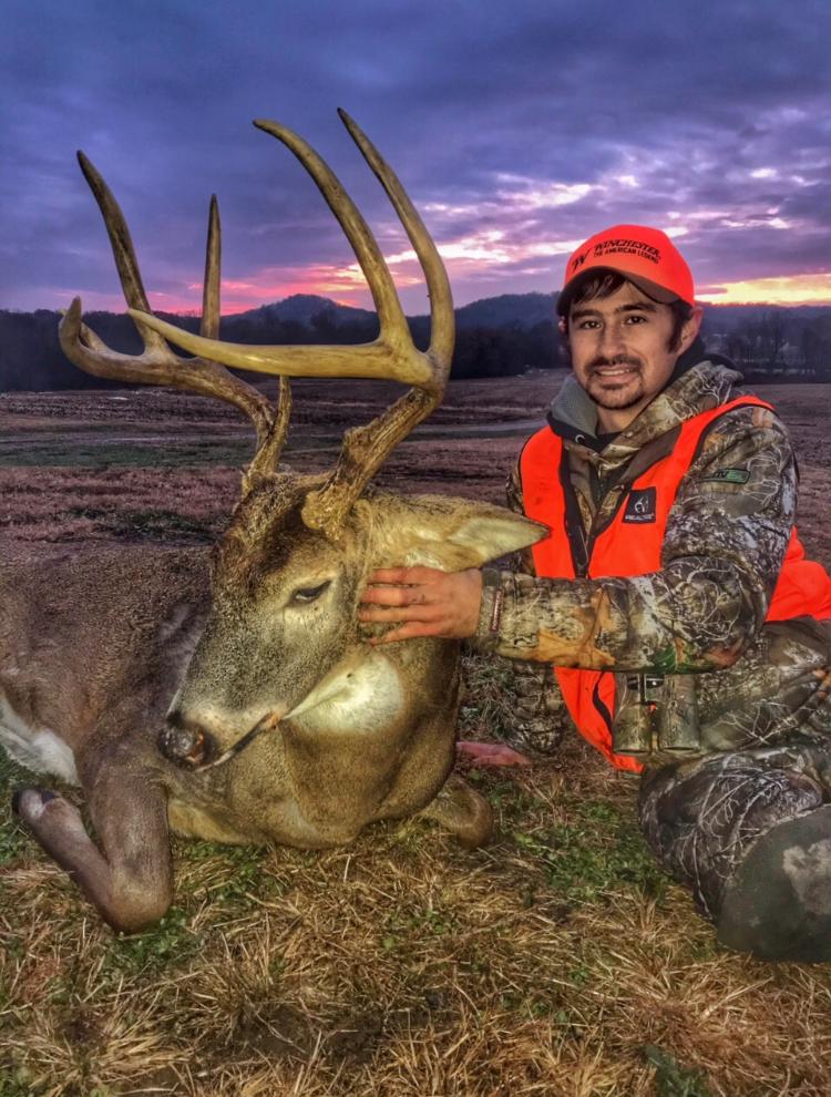 A hunter posing with a buck