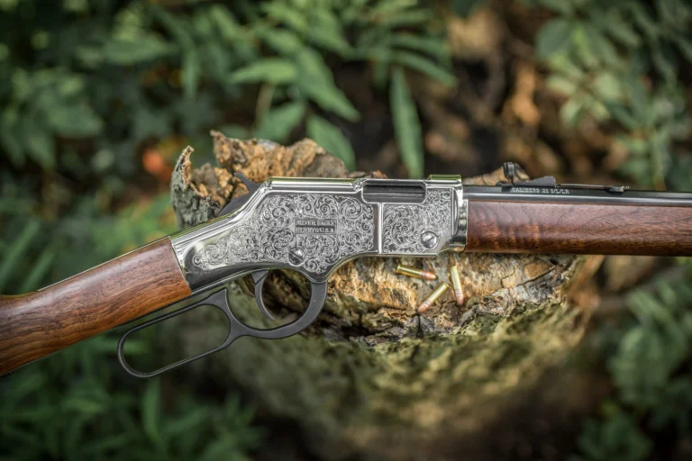Detailed view of a Henry lever-action rifle with intricate engraved silver finish, showcasing the brand's 25th anniversary model