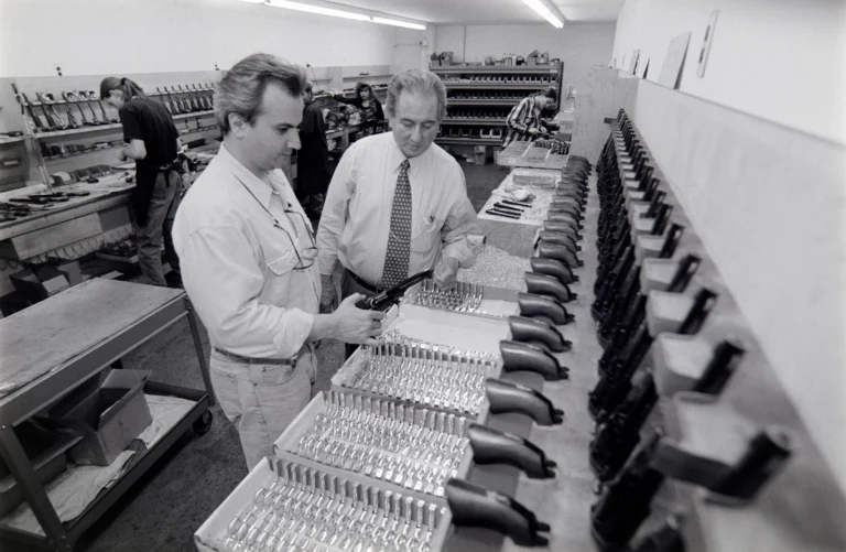 Henry Repeating Arms founders inspect firearm manufacturing at Colt factory in 1995