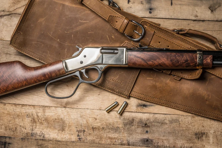 Henry lever-action rifle with wooden stock and barrel on rustic wooden table with ammunition and leather holster