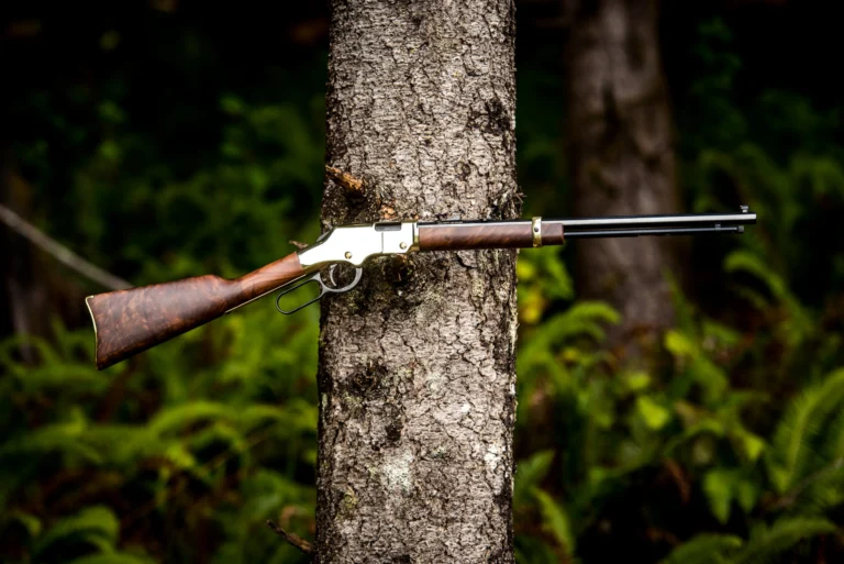 Henry lever-action rifle in a forested setting, showcasing the iconic design and woodgrain stock