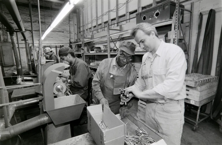 Workers inspecting the production of Henry firearms in the factory