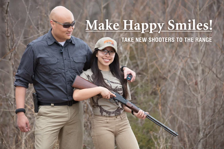 Woman smiling and holding rifle next to man at target shooting range