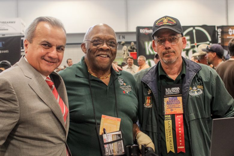 Anthony Imperato embracing fans and smiling for the camera at an NRA Annual Meeting.