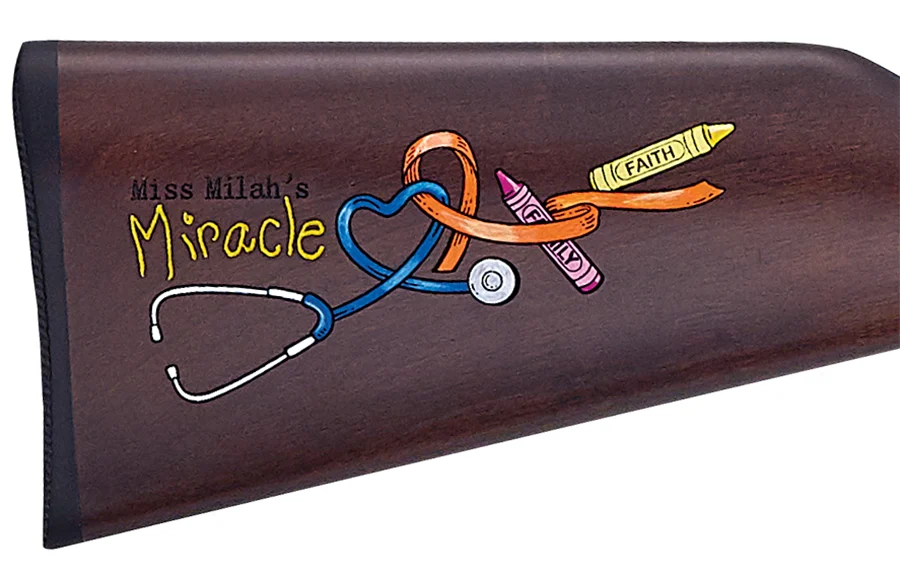 Custom buttstock of 'Miss Milah's Miracle' rifle, featuring painted design with medical symbols and the girl's name