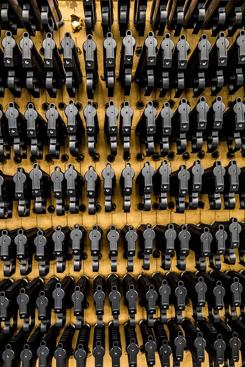 Intricate assembly line at the Henry Repeating Arms factory, showcasing the precision craftsmanship behind their iconic lever-action rifles.