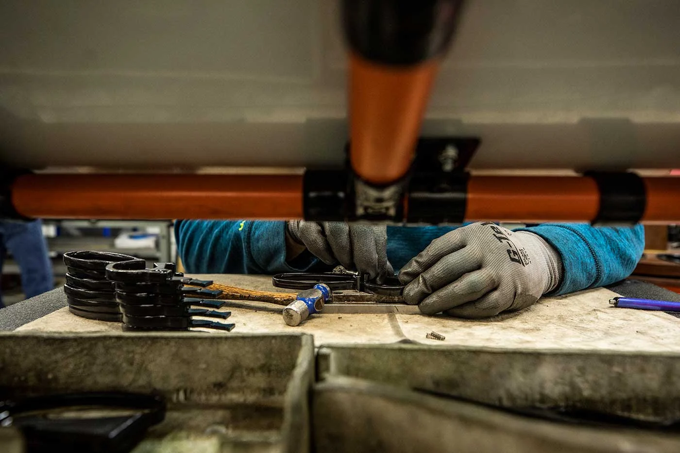 Henry Repeating Arms factory worker assembling and crafting rifle parts on workbench