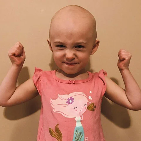 Smiling child in pink shirt with arms raised, Henry firearms supporters