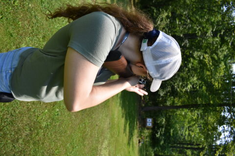 The author shooting a Henry rifle in a standing offhand position.