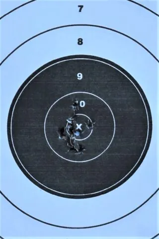 Holes in a paper target showing accuracy.