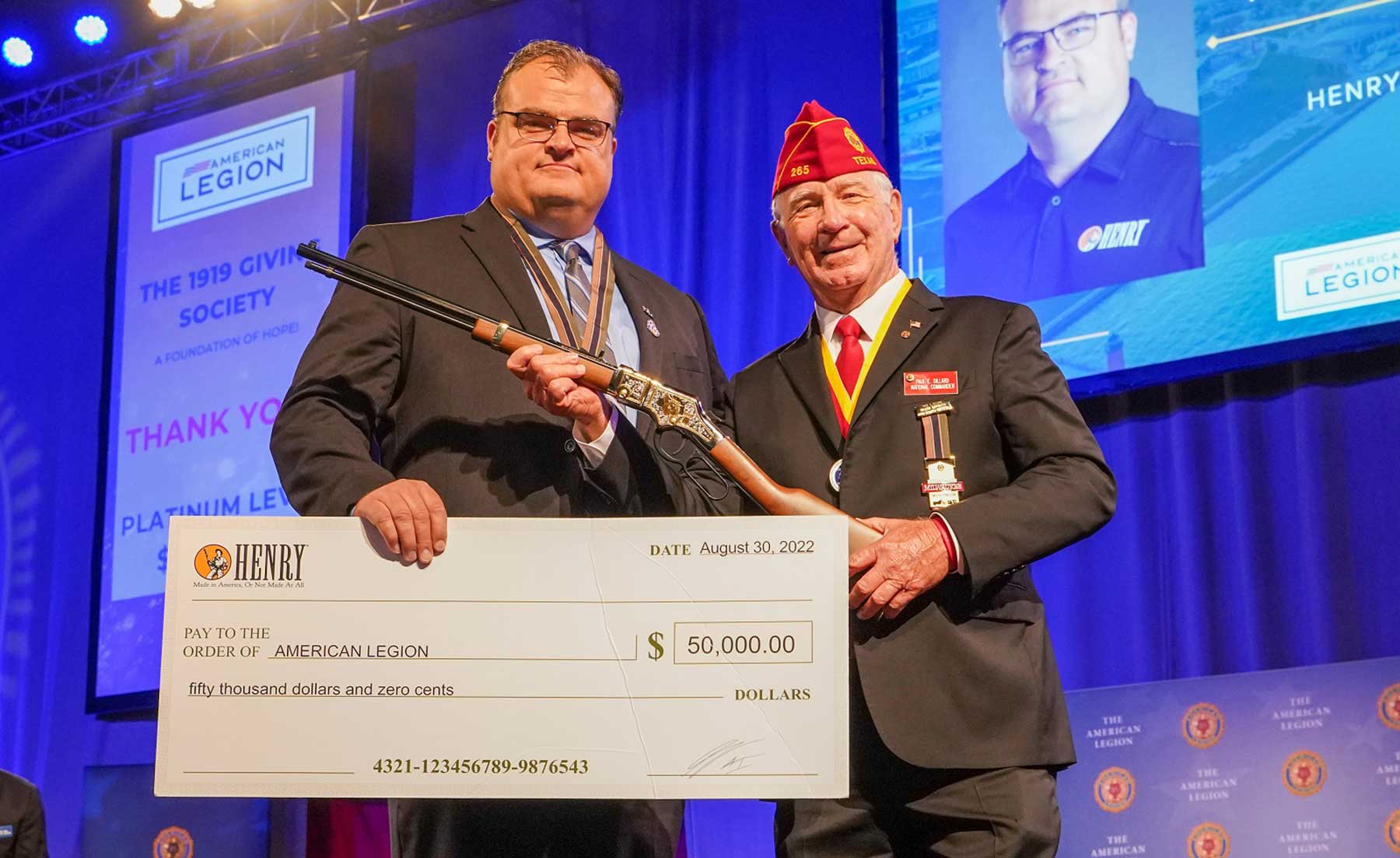Henry Repeating Arms company president presenting $50,000 check to American Legion for veteran support
