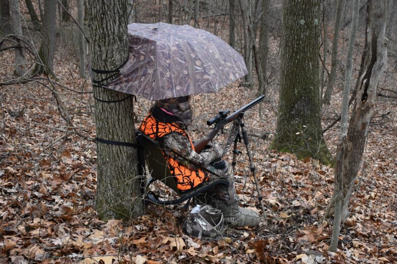 Young hunter in the field waiting at the ready for deer.