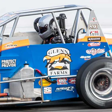 Close-up view of a race car with the Glenn Farms logo and sponsorship decals
