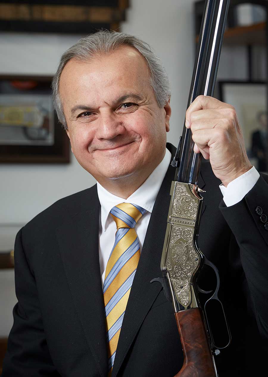 Henry Repeating Arms CEO Anthony Imperato standing in a rifle storage area