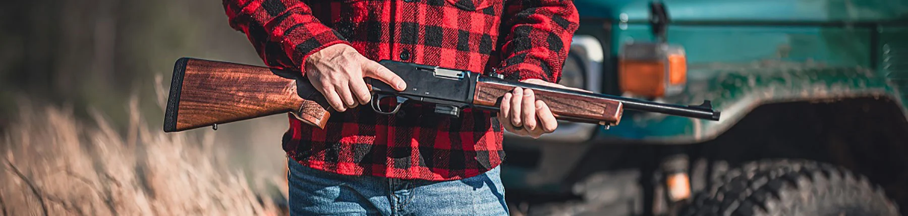 Henry Repeating Arms custom lever-action rifle with wood stock and silver-colored metal parts