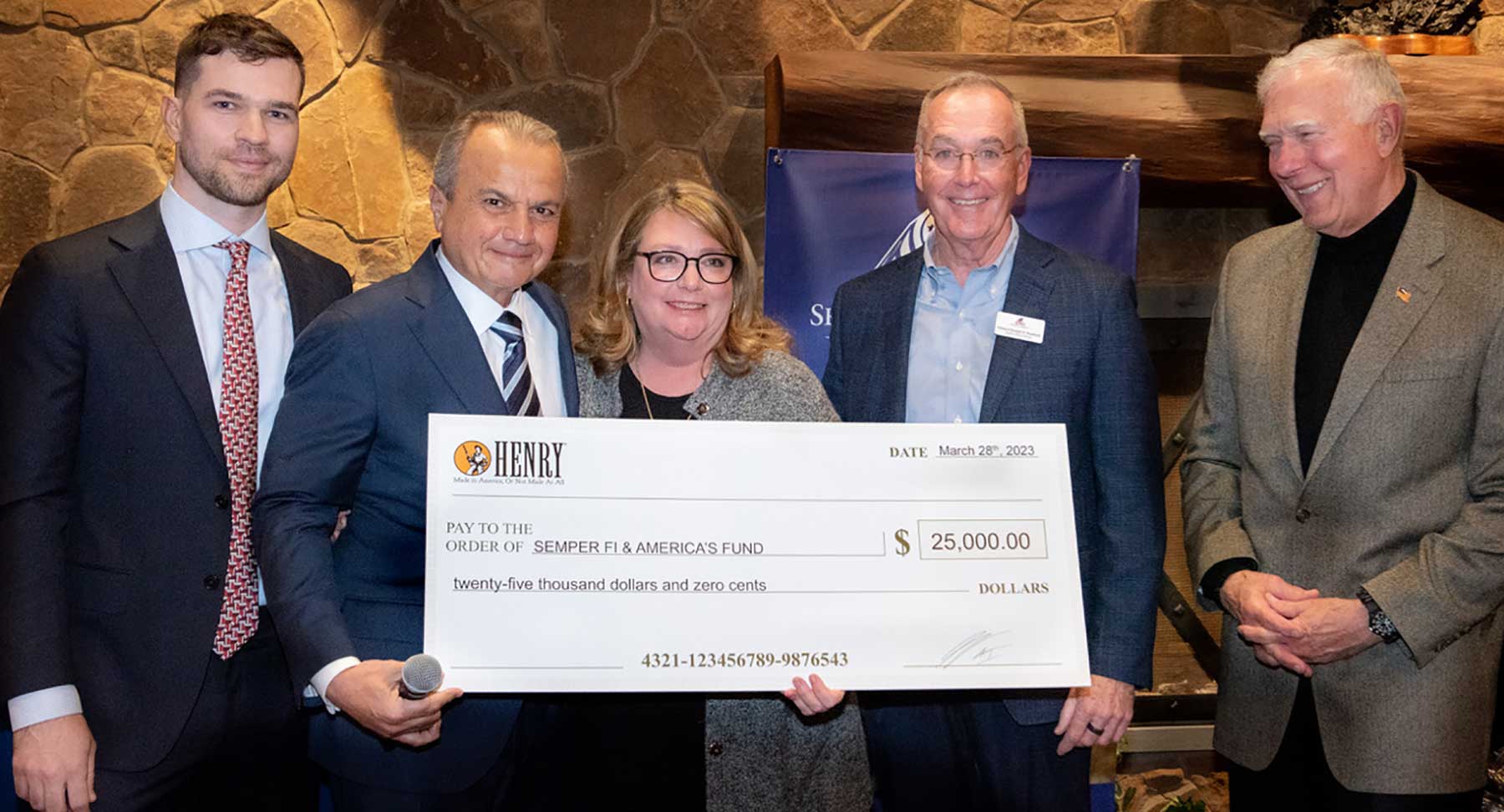 Henry Repeating Arms representatives present a $25,000 donation check to Semper Fi & America's Fund for military veterans