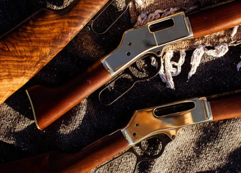 Henry Repeating Arms lever-action rifles showcasing wood stock, metal action, and various firearm components
