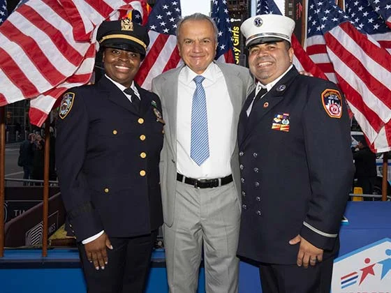 Portrait of Henry Repeating Arms founders and staff posing with American flags