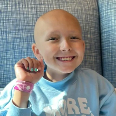 Young smiling cancer patient in Henry Repeating Arms apparel