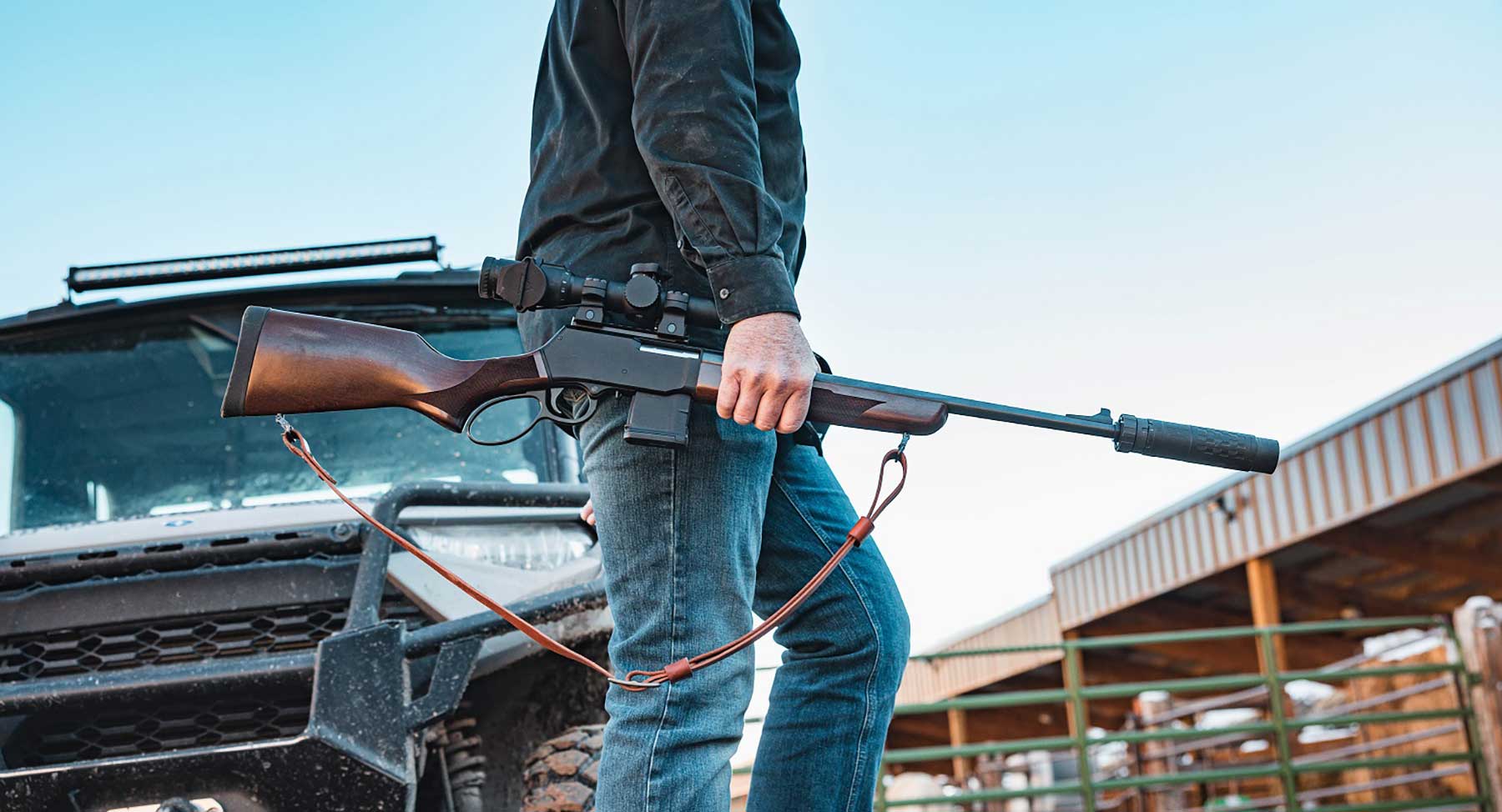Henry Repeating Arms custom lever-action rifle with wood stock and silver-colored metal parts
