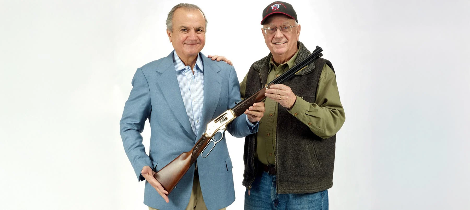 Three men in business suits standing with an award plaque displaying the Henry Repeating Arms logo and branding