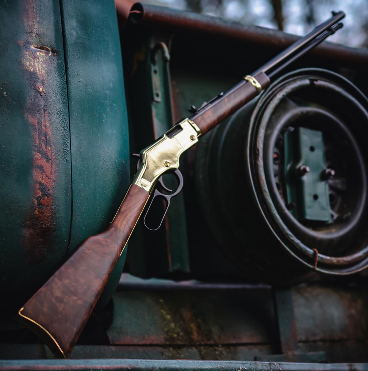 Three men in business suits standing with an award plaque displaying the Henry Repeating Arms logo and branding