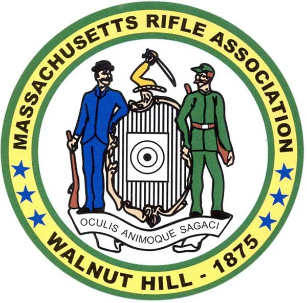 Circular seal of the Massachusetts Rifle Association (Walnut Hill, 1875): two men in blue and green flank a central shield, dagger above, and a scroll with the motto OCULIS ANIMOQUE SAGACI.