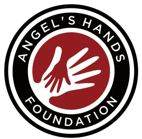 Angel's Hands Foundation logo: white hand silhouette on a red circle, surrounded by a black ring with the organization's name around it.