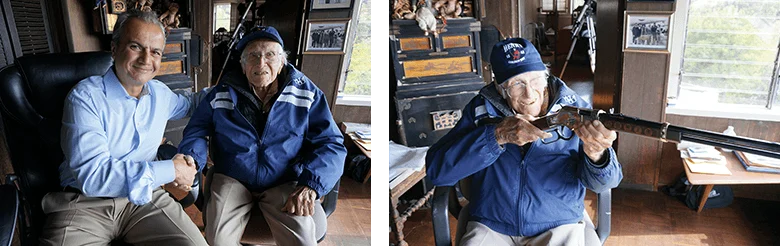 Henry Repeating Arms CEO Anthony Imperato shaking hands with customer Louis Zamperini holding engraved lever-action rifle